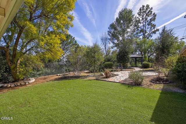 view of yard with fence and a gazebo