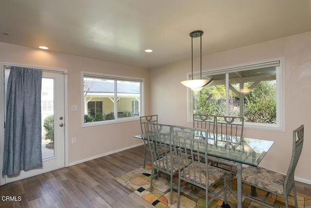 dining space featuring recessed lighting, baseboards, and wood finished floors