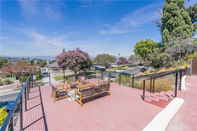 surrounding community featuring a patio area and an outdoor hangout area