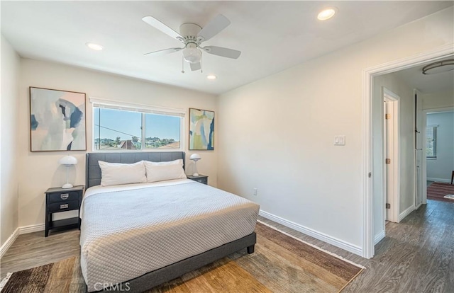 bedroom with ceiling fan, recessed lighting, wood finished floors, and baseboards