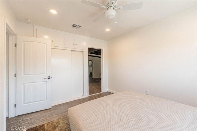 bedroom with recessed lighting, a closet, visible vents, a ceiling fan, and wood finished floors