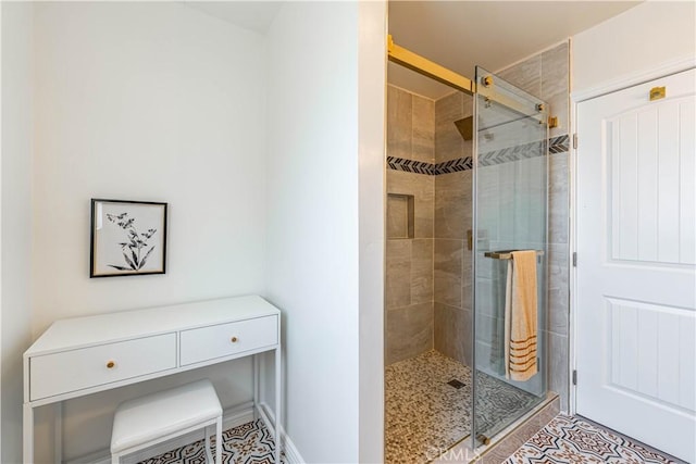 bathroom with tile patterned flooring and a shower stall