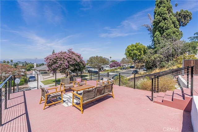 view of property's community featuring a patio area and an outdoor living space