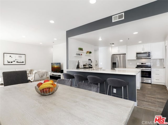 dining room featuring recessed lighting, visible vents, and dark wood finished floors