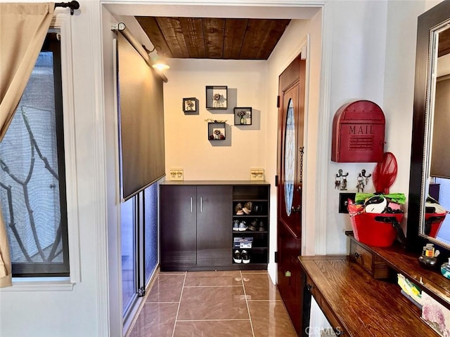 corridor featuring wood ceiling and tile patterned floors