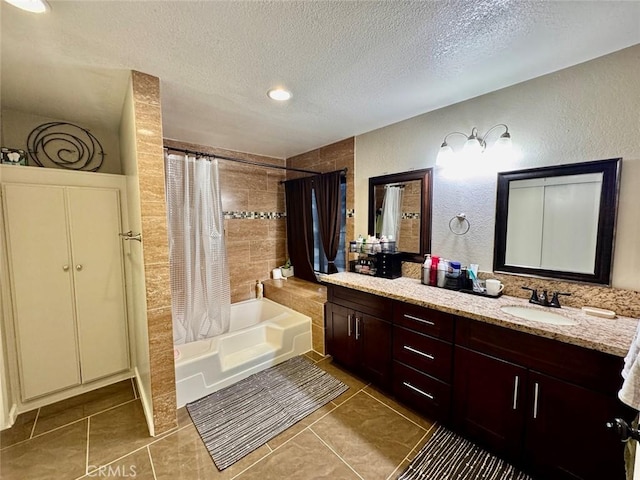 bathroom featuring shower / bath combo, a textured ceiling, vanity, and tile patterned floors