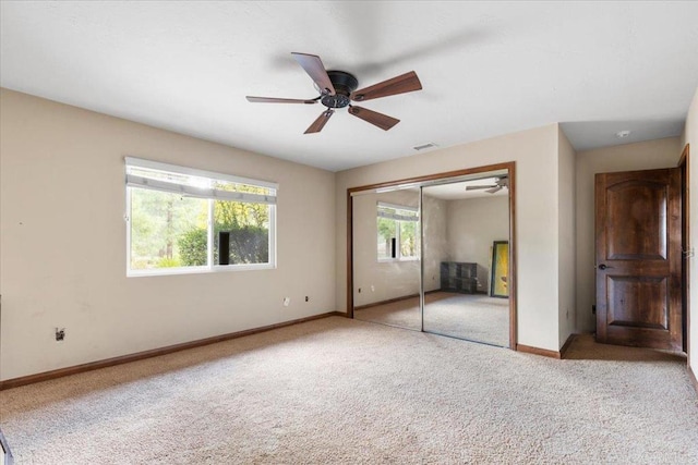 unfurnished bedroom with a ceiling fan, a closet, carpet flooring, and baseboards