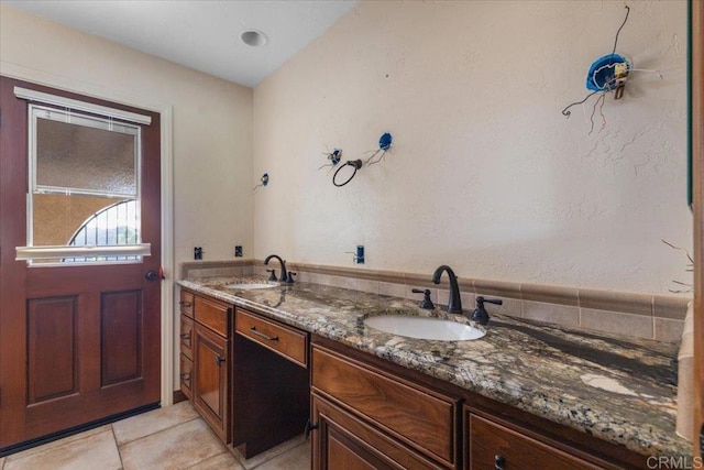 bathroom featuring double vanity, tile patterned flooring, and a sink