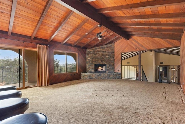 unfurnished living room featuring vaulted ceiling with beams, ceiling fan, wood walls, and a fireplace