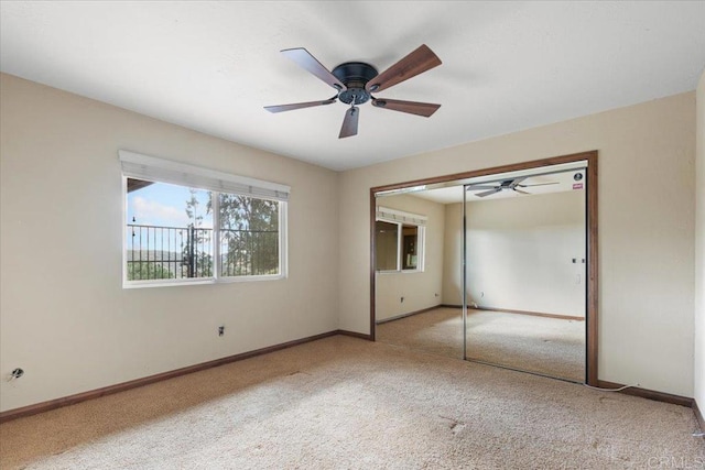 unfurnished bedroom with a closet, carpet flooring, ceiling fan, and baseboards