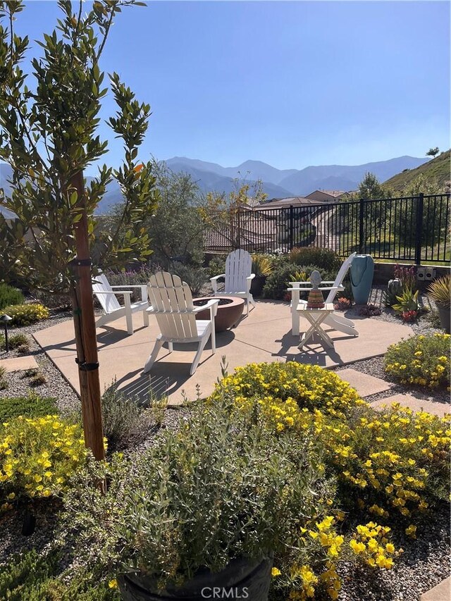 24674 Crestley Dr, Corona, CA 92883 - view of patio / terrace with an outdoor fire pit and a mountain view