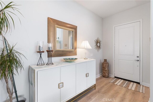24674 Crestley Dr, Corona, CA 92883 - entryway with light wood-style floors and baseboards