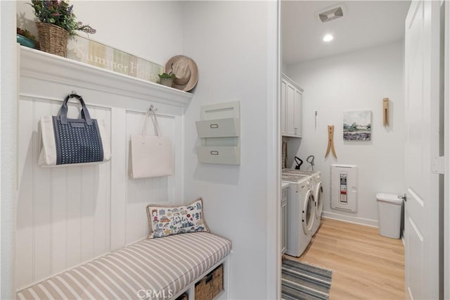 24674 Crestley Dr, Corona, CA 92883 - washroom with washing machine and clothes dryer, cabinet space, light wood-style flooring, and recessed lighting