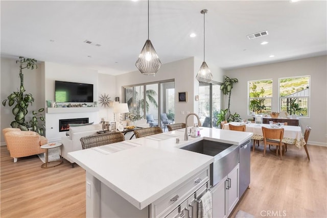 24674 Crestley Dr, Corona, CA 92883 - kitchen with a sink, light wood-style flooring, light countertops, pendant lighting, and recessed lighting
