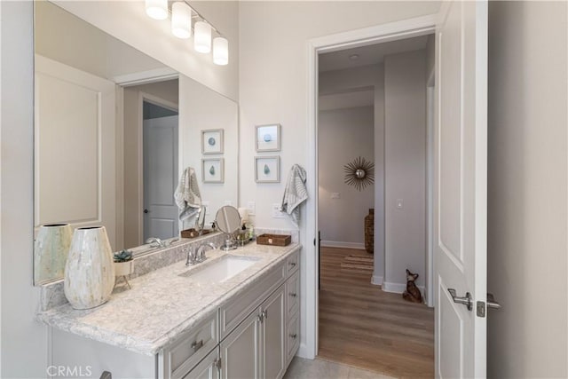 24674 Crestley Dr, Corona, CA 92883 - bathroom with vanity, baseboards, and wood finished floors