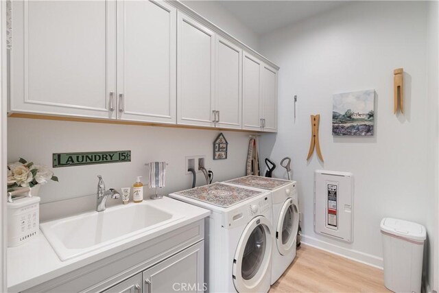 24674 Crestley Dr, Corona, CA 92883 - laundry area with independent washer and dryer, cabinet space, light wood-style floors, and baseboards