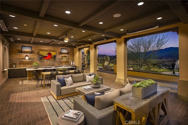 24674 Crestley Dr, Corona, CA 92883 - patio terrace at dusk with a mountain view, outdoor lounge area, outdoor dining space, and a patio