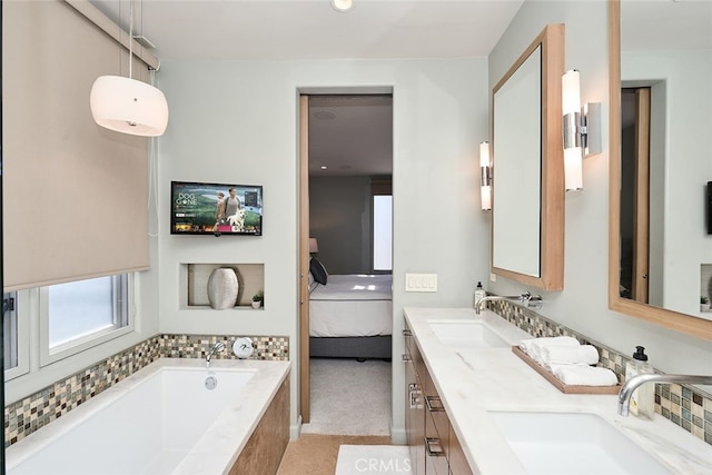 ensuite bathroom featuring a garden tub, a sink, ensuite bath, and double vanity