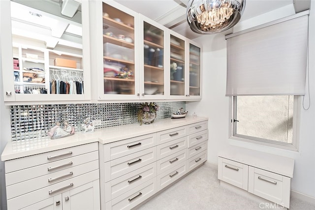 walk in closet featuring light colored carpet