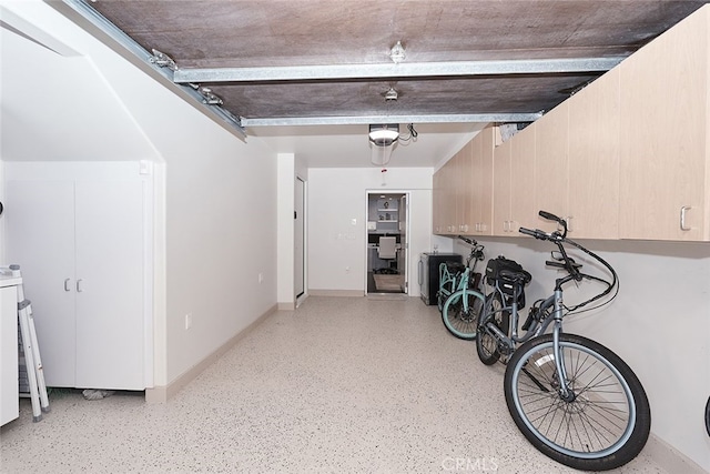 garage with baseboards and a garage door opener