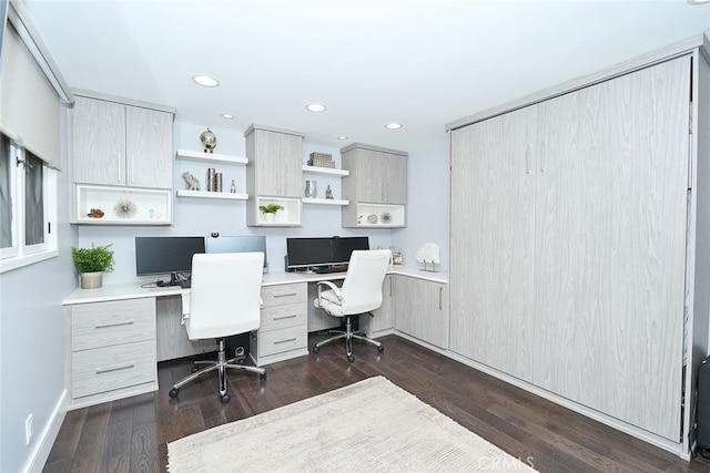 home office featuring dark wood-type flooring, recessed lighting, and built in study area