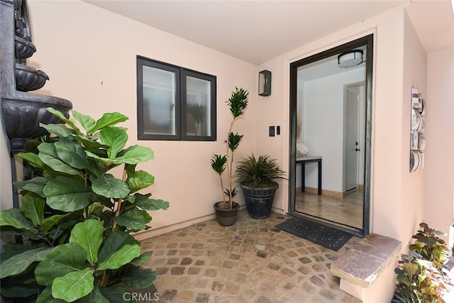 view of exterior entry with stucco siding