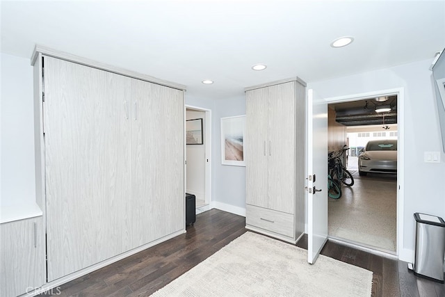 interior space featuring baseboards, wood finished floors, and recessed lighting