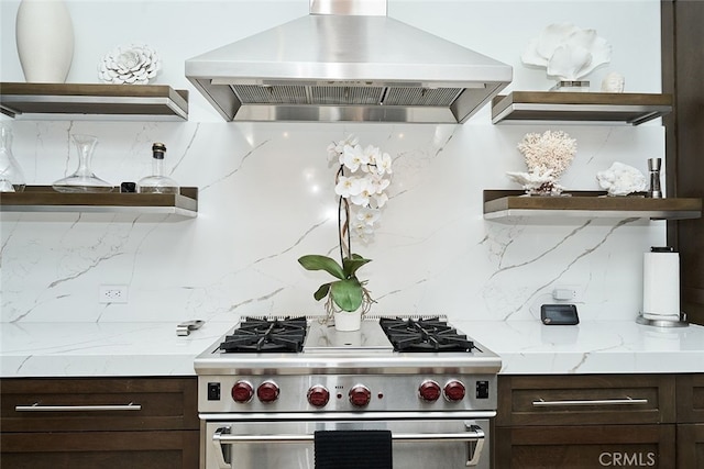 kitchen with dark brown cabinets, range hood, high end stainless steel range oven, decorative backsplash, and open shelves