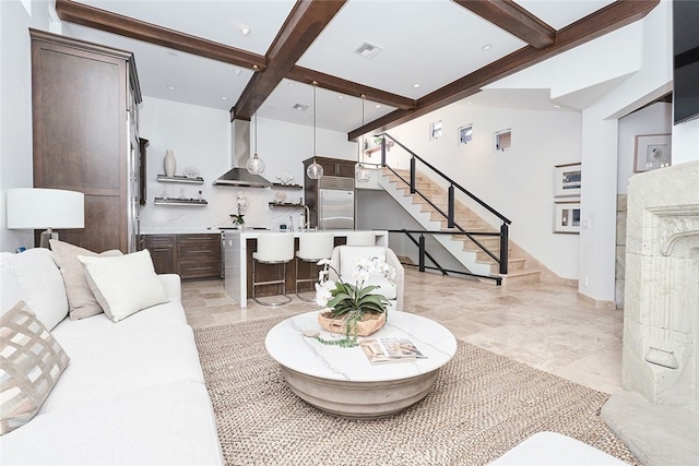 living room featuring stairs, indoor wet bar, and beam ceiling