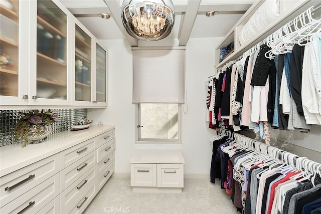 walk in closet featuring light colored carpet