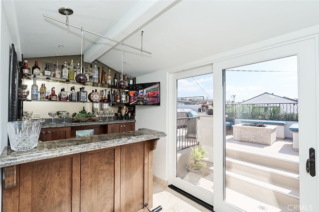 bar featuring lofted ceiling with beams, a dry bar, and a sunroom