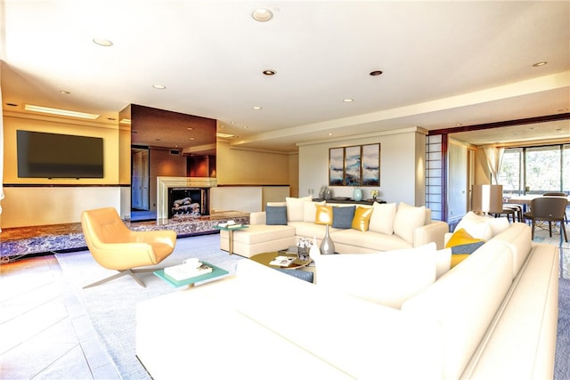 tiled living area with recessed lighting and a fireplace with raised hearth