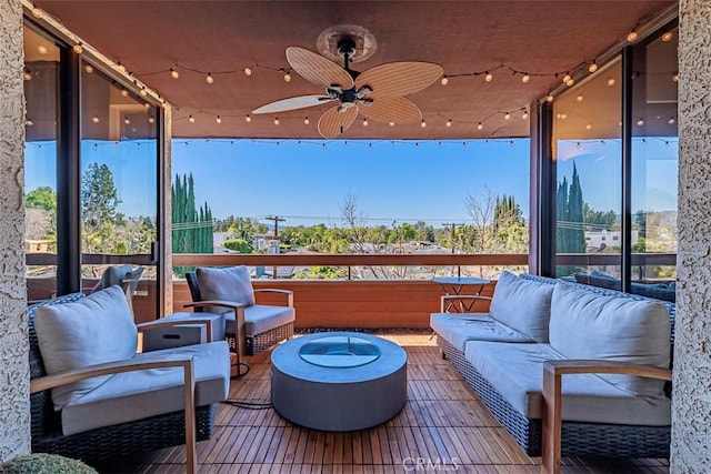 view of patio with an outdoor living space and a ceiling fan