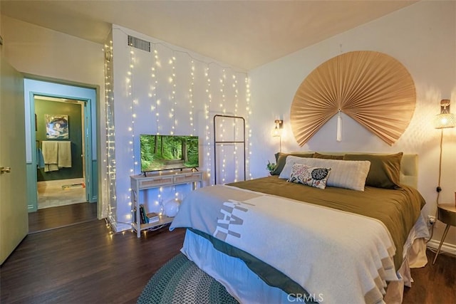 bedroom with wood finished floors and visible vents