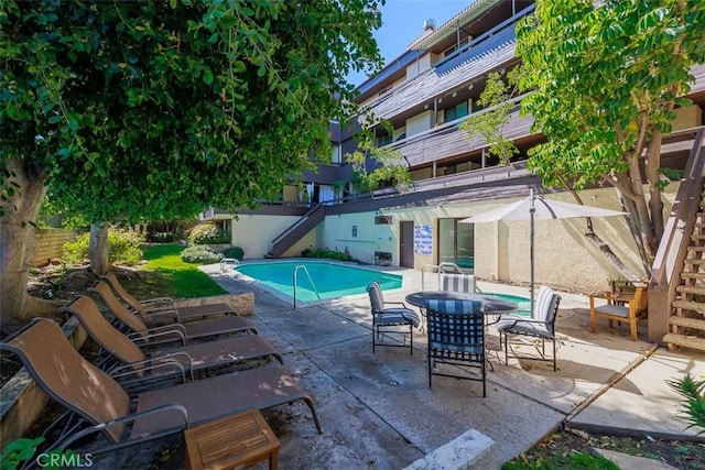 pool with stairs and a patio area