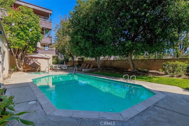 view of swimming pool with a patio area, a fenced in pool, and a fenced backyard