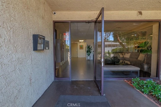 entrance to property featuring stucco siding