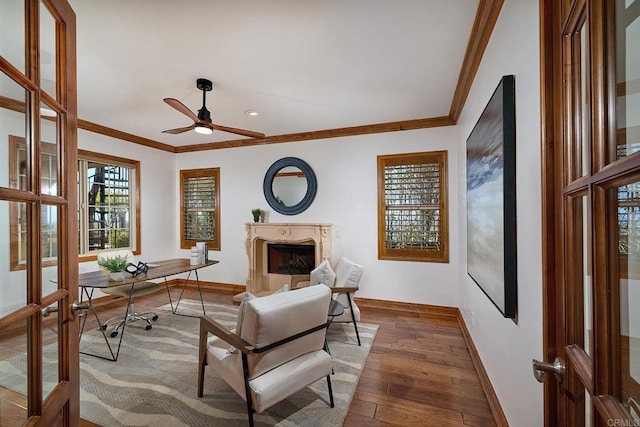 office with baseboards, crown molding, wood-type flooring, and a premium fireplace