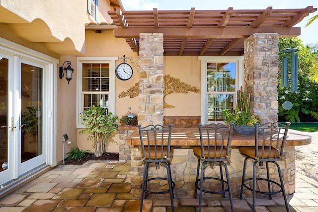 view of patio with outdoor dry bar and a pergola