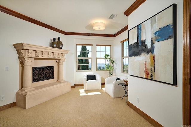 sitting room with crown molding, carpet flooring, baseboards, and visible vents