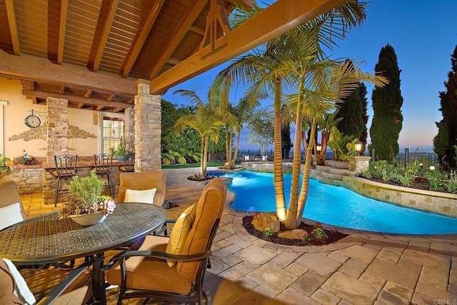 pool with a patio and outdoor dining area