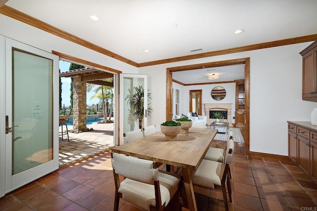 dining space with visible vents, baseboards, ornamental molding, recessed lighting, and a fireplace