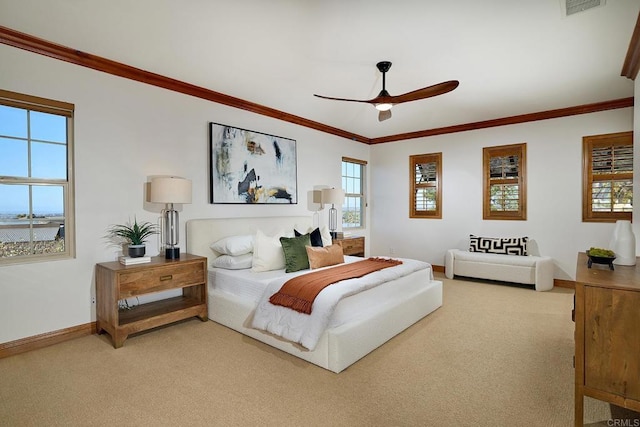 bedroom featuring light colored carpet, ornamental molding, and multiple windows