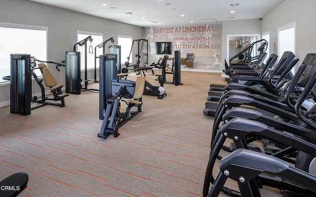 gym with recessed lighting, light colored carpet, and baseboards