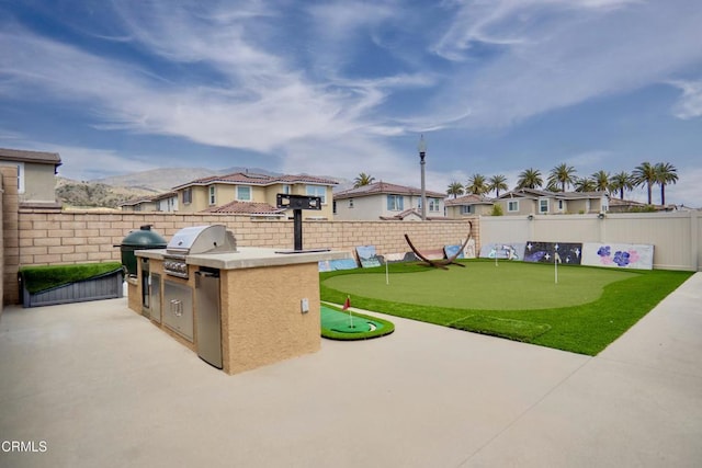 view of patio / terrace featuring a fenced backyard, area for grilling, a grill, and a residential view