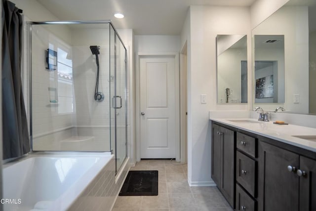 bathroom featuring a tub to relax in, double vanity, visible vents, a sink, and a shower stall