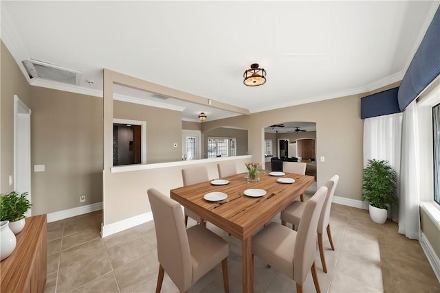 dining area featuring ornamental molding, light tile patterned flooring, visible vents, and baseboards