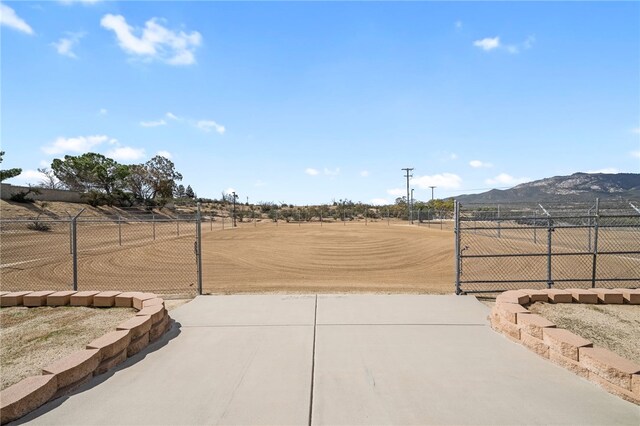 view of yard featuring fence and a mountain view