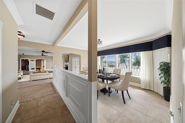 dining space with visible vents, ornamental molding, beamed ceiling, and light tile patterned flooring