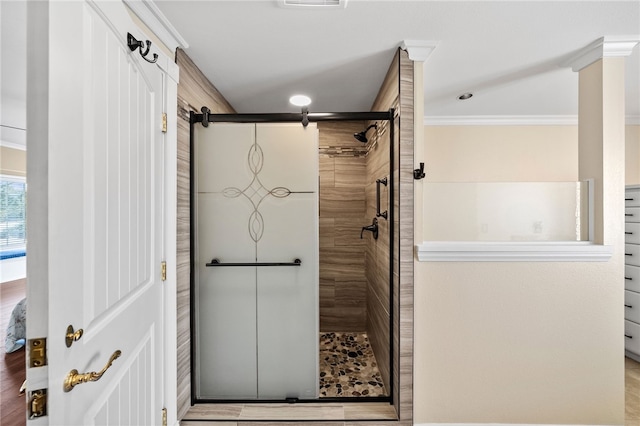 bathroom with ornamental molding, visible vents, and a shower stall